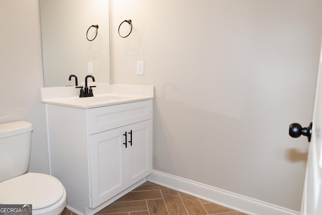 bathroom featuring vanity and toilet