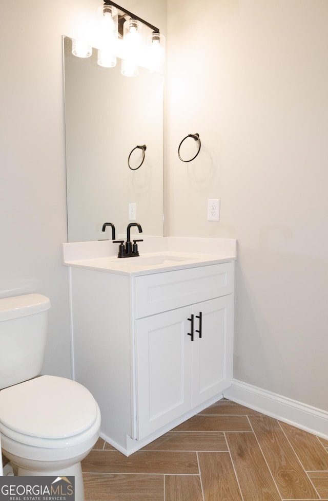 bathroom featuring vanity and toilet