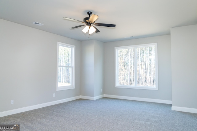 unfurnished room with ceiling fan and carpet floors