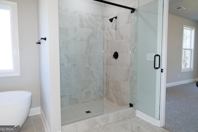 bathroom with shower with separate bathtub, tile patterned floors, and plenty of natural light