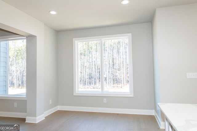 unfurnished room with light wood-type flooring