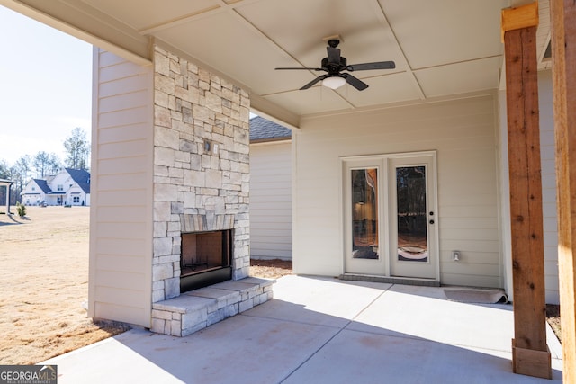 view of patio / terrace featuring an outdoor stone fireplace and ceiling fan