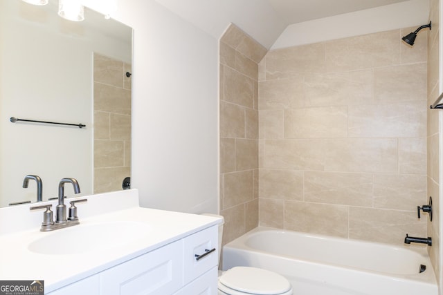 full bathroom featuring vanity, toilet, and tiled shower / bath combo