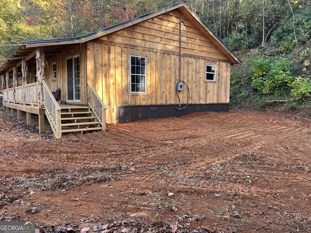 view of side of property with a porch