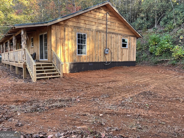 view of side of property featuring a porch