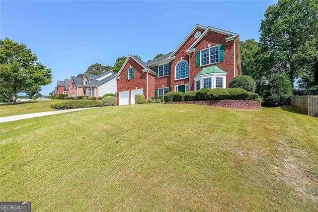 view of front of home with a front yard and a garage