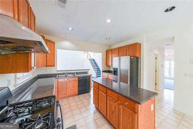 kitchen with range hood, black appliances, plenty of natural light, and a kitchen island