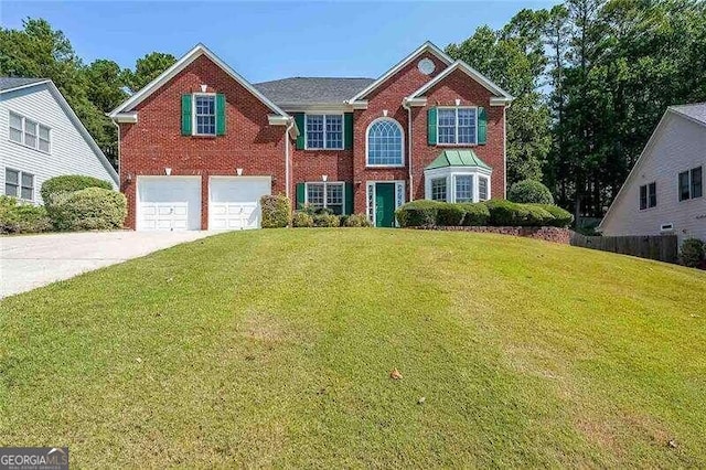 view of front of property with a front lawn and a garage