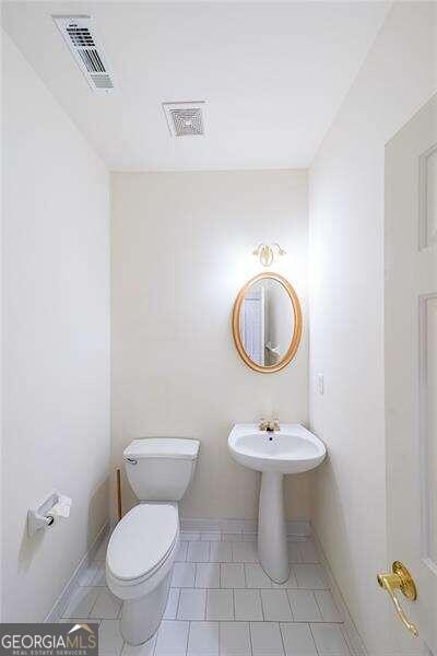 bathroom with tile patterned floors and toilet