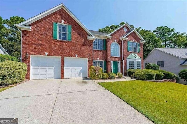 view of front of home featuring a front yard and a garage