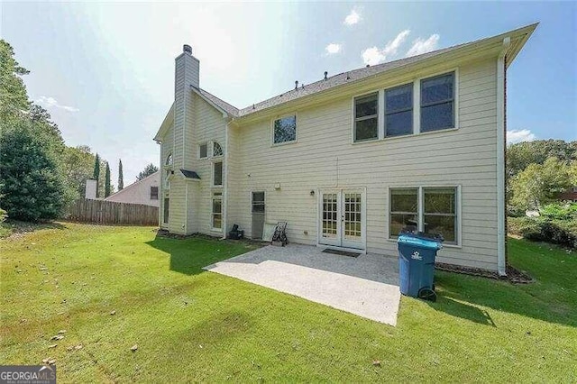 rear view of house featuring a patio and a lawn