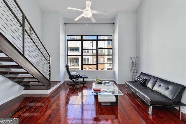 living room featuring dark hardwood / wood-style floors and ceiling fan