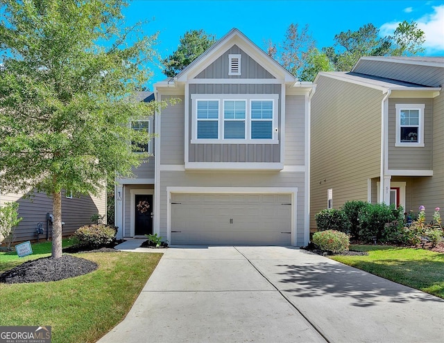 view of front of property featuring a garage and a front lawn