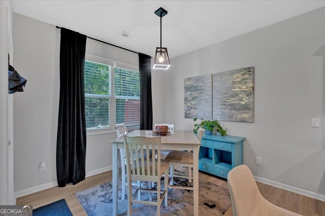 dining space with light wood-type flooring