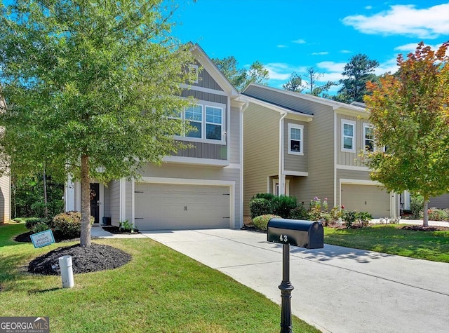 view of front of home featuring a front lawn and a garage