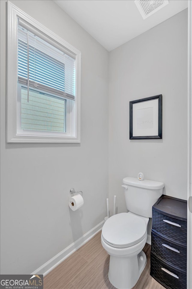 bathroom featuring hardwood / wood-style floors and toilet