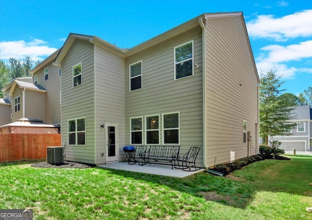 back of house featuring a yard, a patio, and central air condition unit