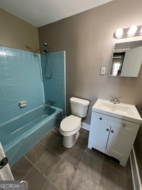 full bathroom with toilet, tiled shower / bath, vanity, and tile patterned floors