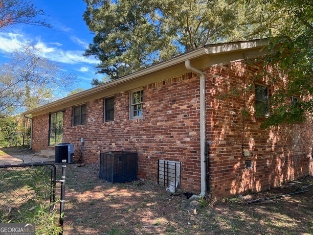 view of side of property with central air condition unit