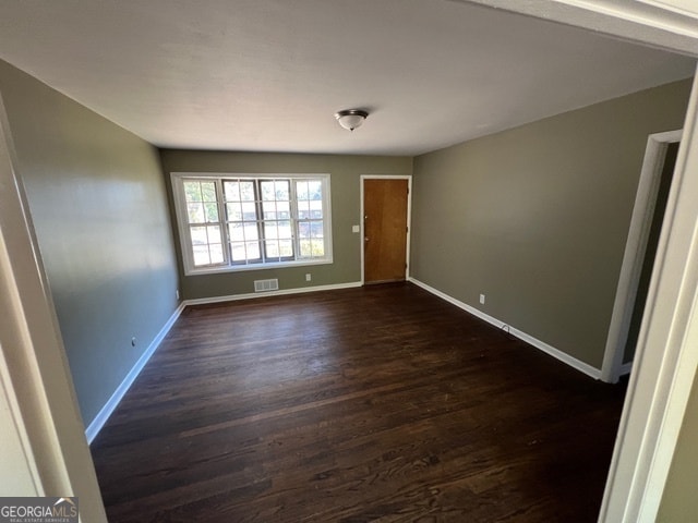 unfurnished room featuring dark hardwood / wood-style flooring