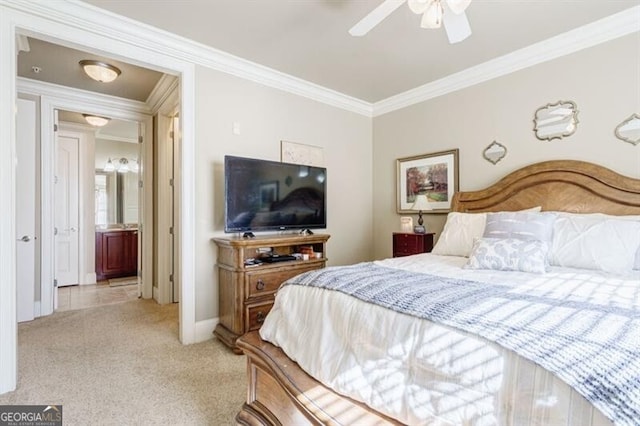 bedroom featuring ensuite bathroom, crown molding, light colored carpet, and ceiling fan