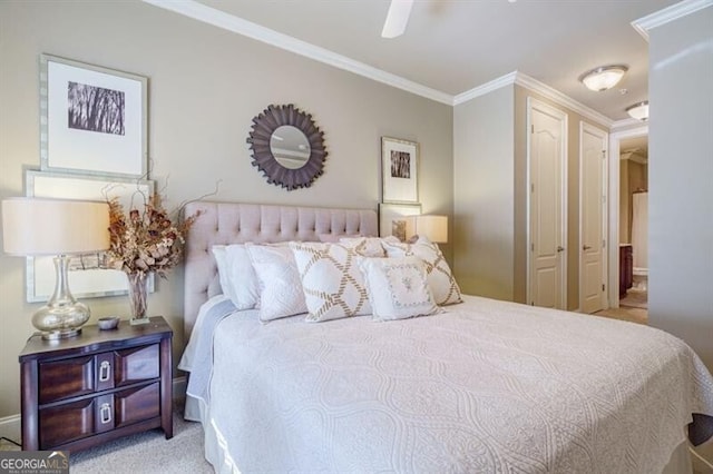 carpeted bedroom featuring ornamental molding and ceiling fan