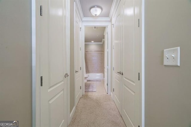 hall featuring crown molding and light colored carpet