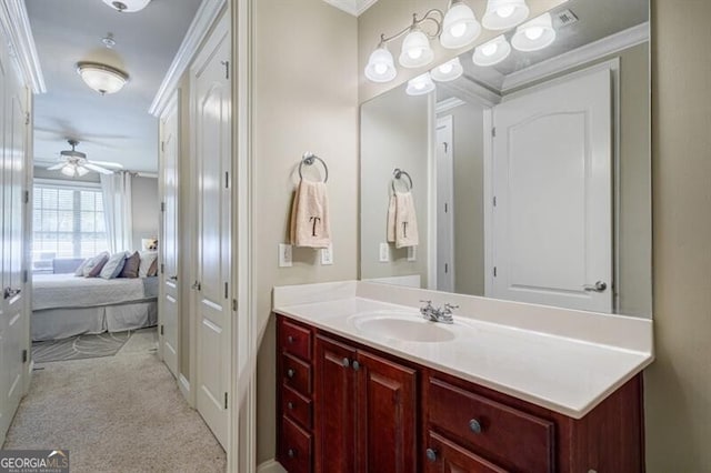 bathroom featuring vanity, crown molding, and ceiling fan