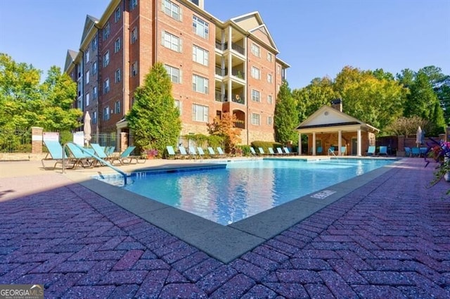 view of pool with a patio and a gazebo