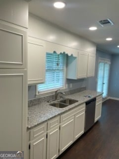 kitchen featuring white cabinets, stainless steel dishwasher, sink, and plenty of natural light