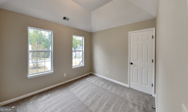 spare room featuring light colored carpet