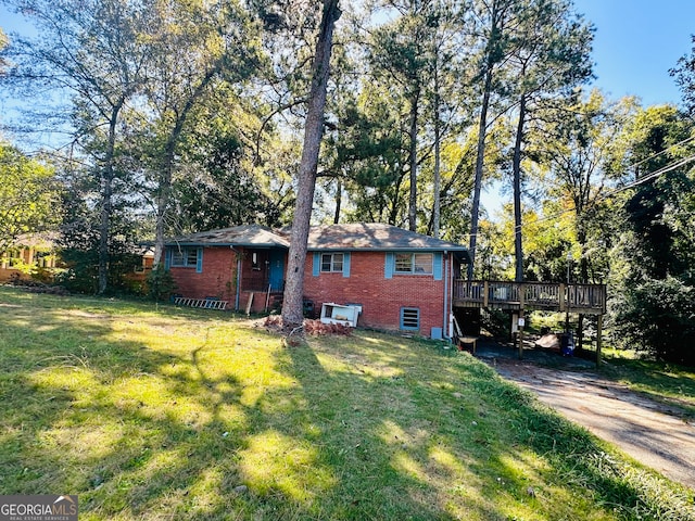 view of front of house with a front lawn and a wooden deck