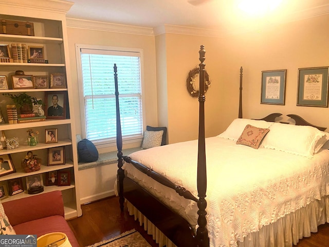 bedroom featuring crown molding and dark wood-type flooring