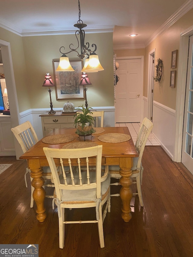 dining space with ornamental molding and hardwood / wood-style floors