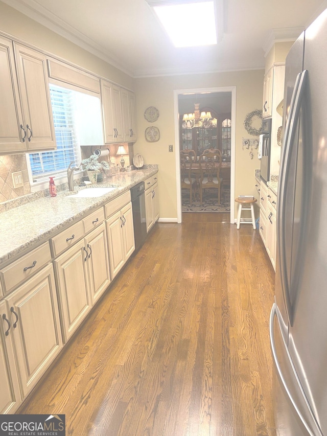 kitchen featuring sink, stainless steel appliances, light stone counters, tasteful backsplash, and dark hardwood / wood-style flooring