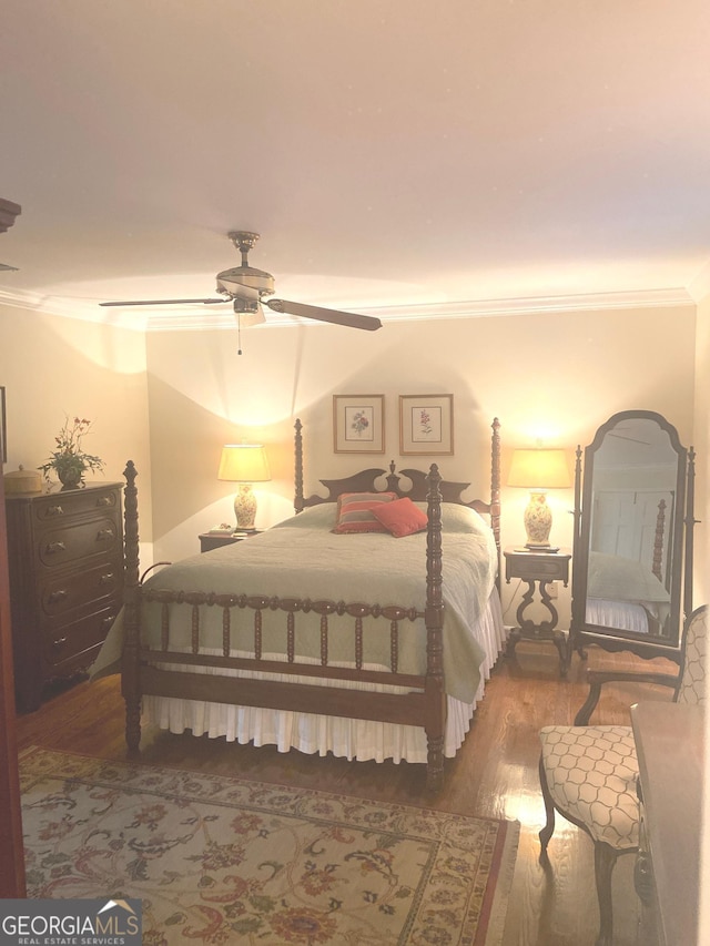 bedroom with hardwood / wood-style flooring, ceiling fan, and crown molding