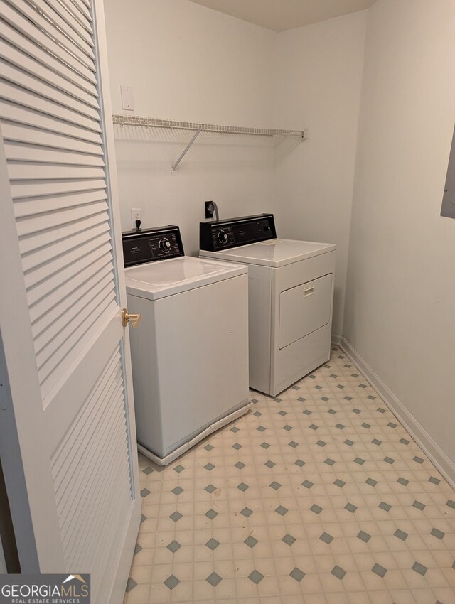 clothes washing area featuring washer and clothes dryer