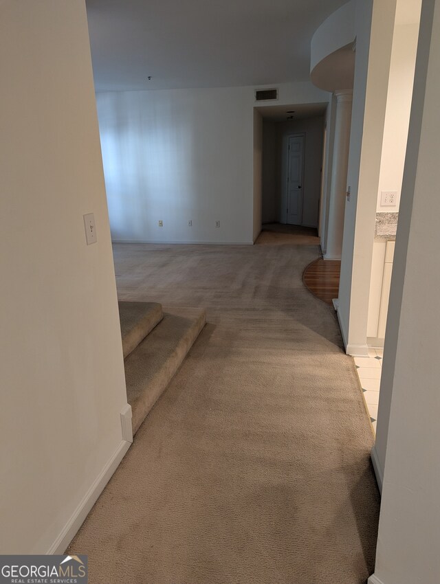 hall featuring light colored carpet