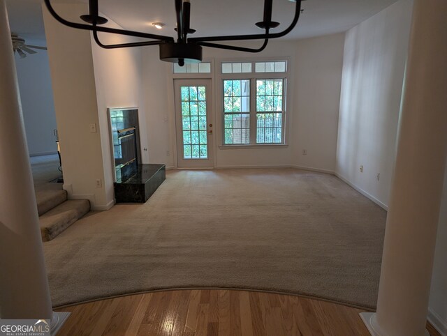 unfurnished living room featuring ceiling fan and light hardwood / wood-style flooring