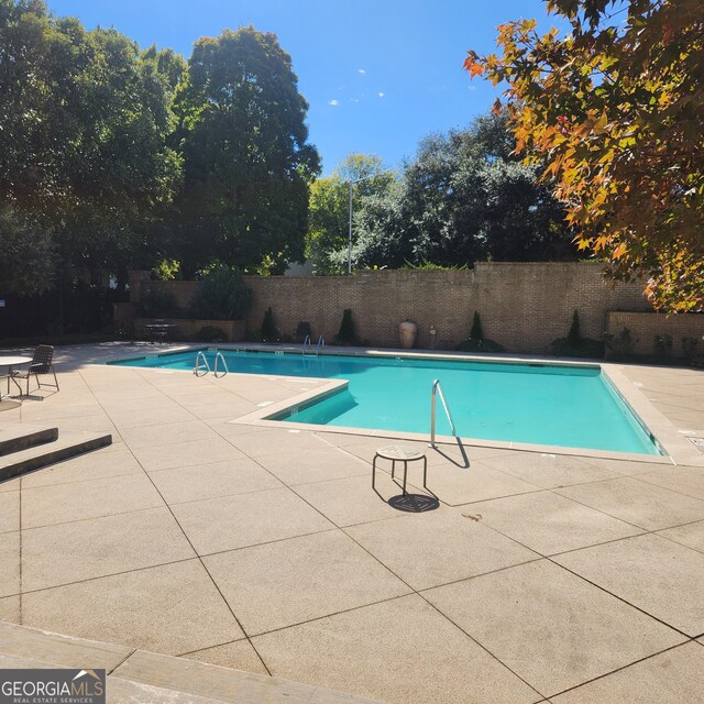 view of swimming pool with a patio area