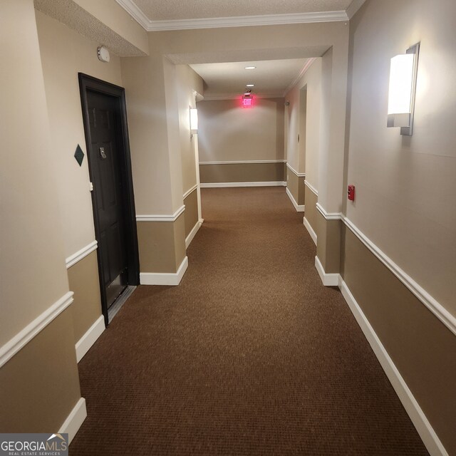 corridor with dark carpet and crown molding