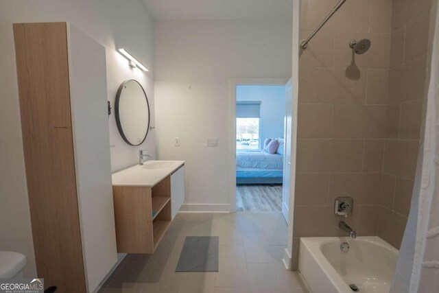 full bathroom with vanity, shower / tub combo with curtain, tile patterned floors, and toilet