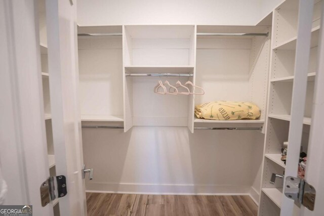 spacious closet featuring hardwood / wood-style flooring