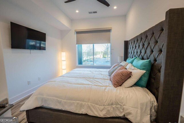 bedroom with ceiling fan and hardwood / wood-style flooring