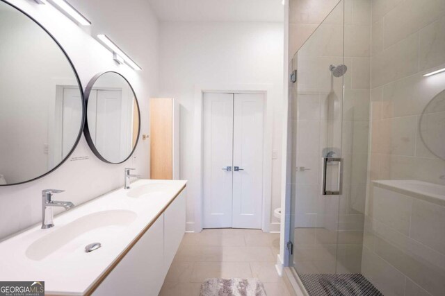 bathroom with vanity, tile patterned floors, toilet, and an enclosed shower