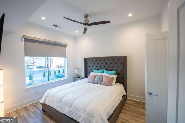 bedroom with light hardwood / wood-style floors and ceiling fan