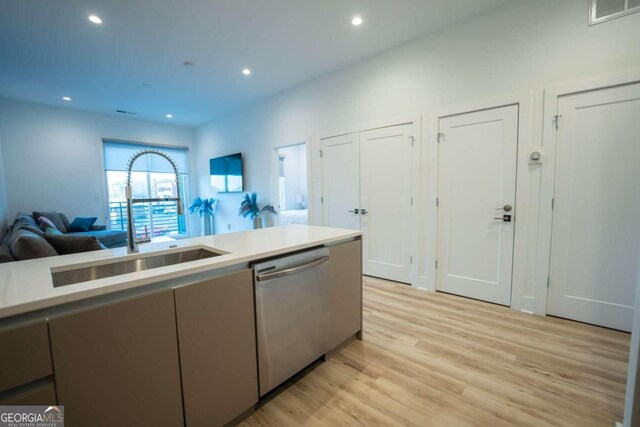 kitchen featuring sink, light hardwood / wood-style flooring, and dishwasher