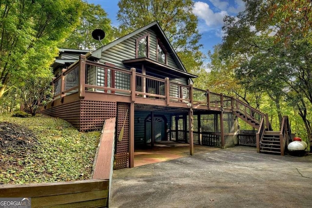 rear view of property with a patio area and a deck