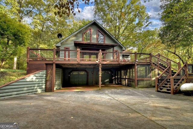 view of front of home with a deck and a garage