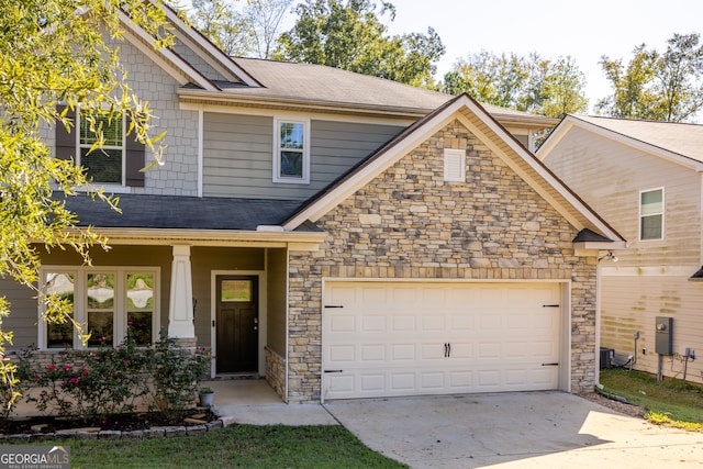 craftsman-style home with covered porch, a garage, and central AC unit